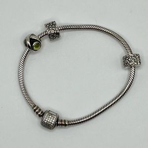 Authentic Pandora bracelet, two stoppers and retired Green Peridot Eye Charm